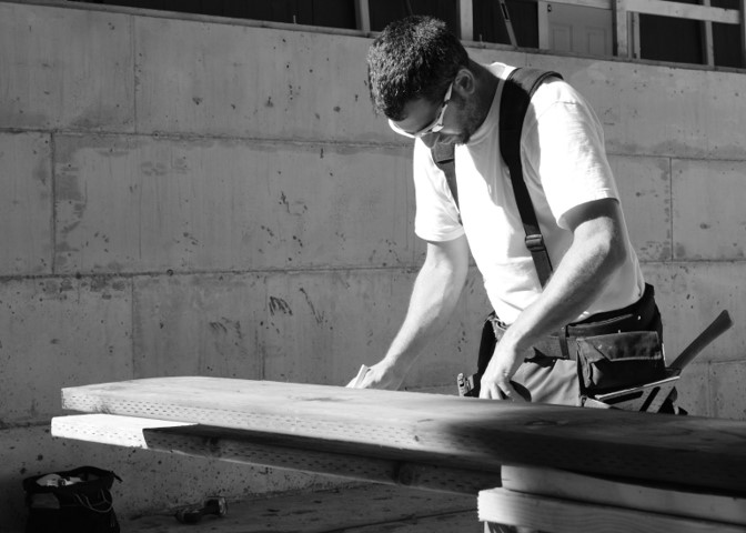 Louis Blanco measuring lumber during construction